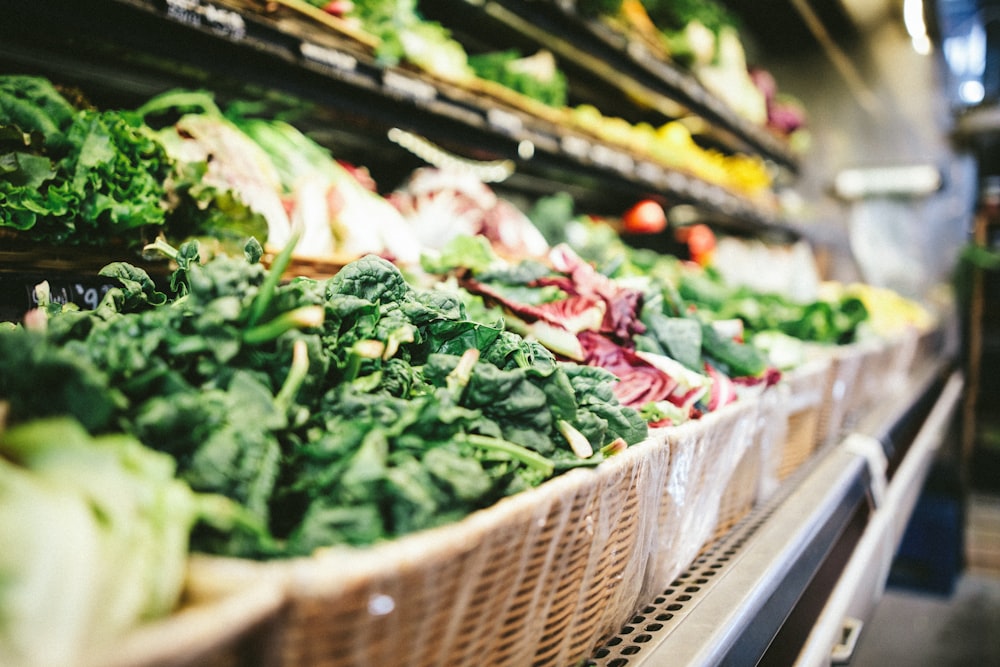 row of vegetables placed on multilayered display fridge