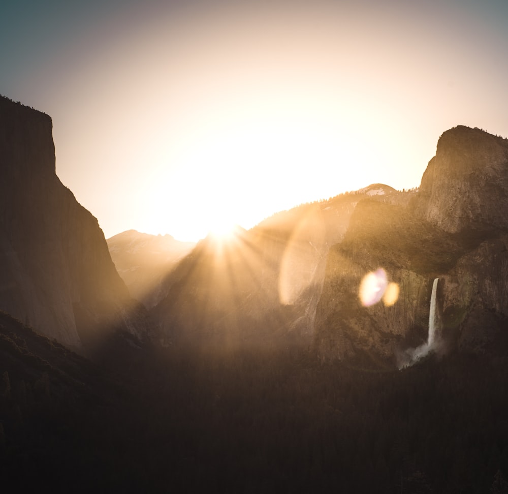 sun shining through mountain ranges