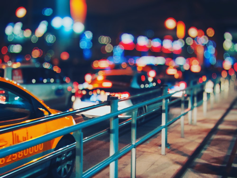 selective focus photo of cars on road with bokeh lights