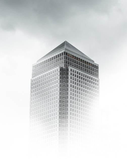 worm's-eye view photography of white and gray concrete building under cloudy sky
