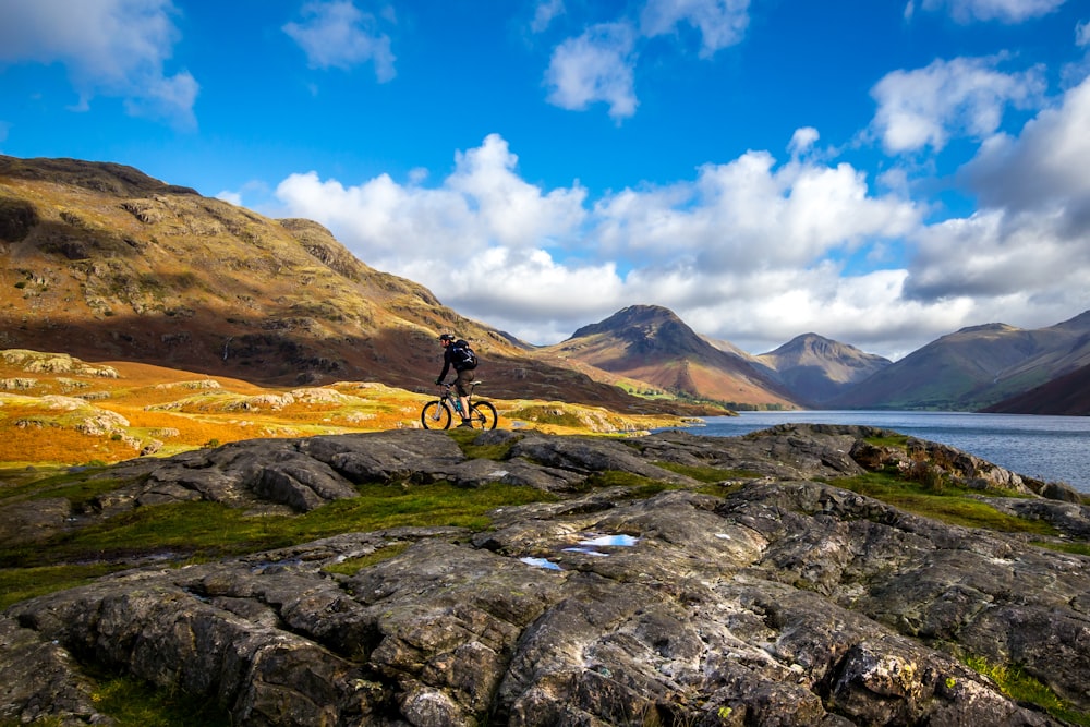 man riding bike through rocks