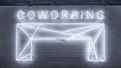 A creative workspace illuminated by modern lighting, with stylish branding elements.