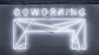A creative team collaborating around a sleek workspace with glowing neon accents.