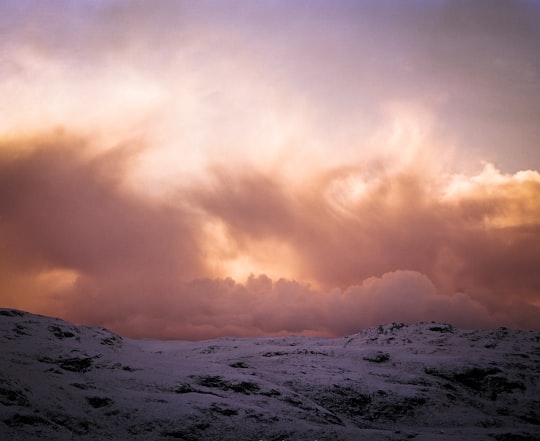 mountain covered with snow under cloudy sky in Skye United Kingdom