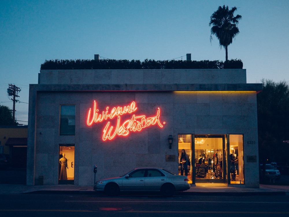 silver sedan parked in front of store