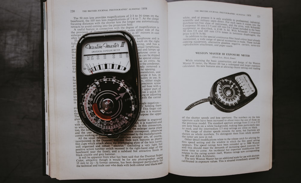 black measuring tool on opened book