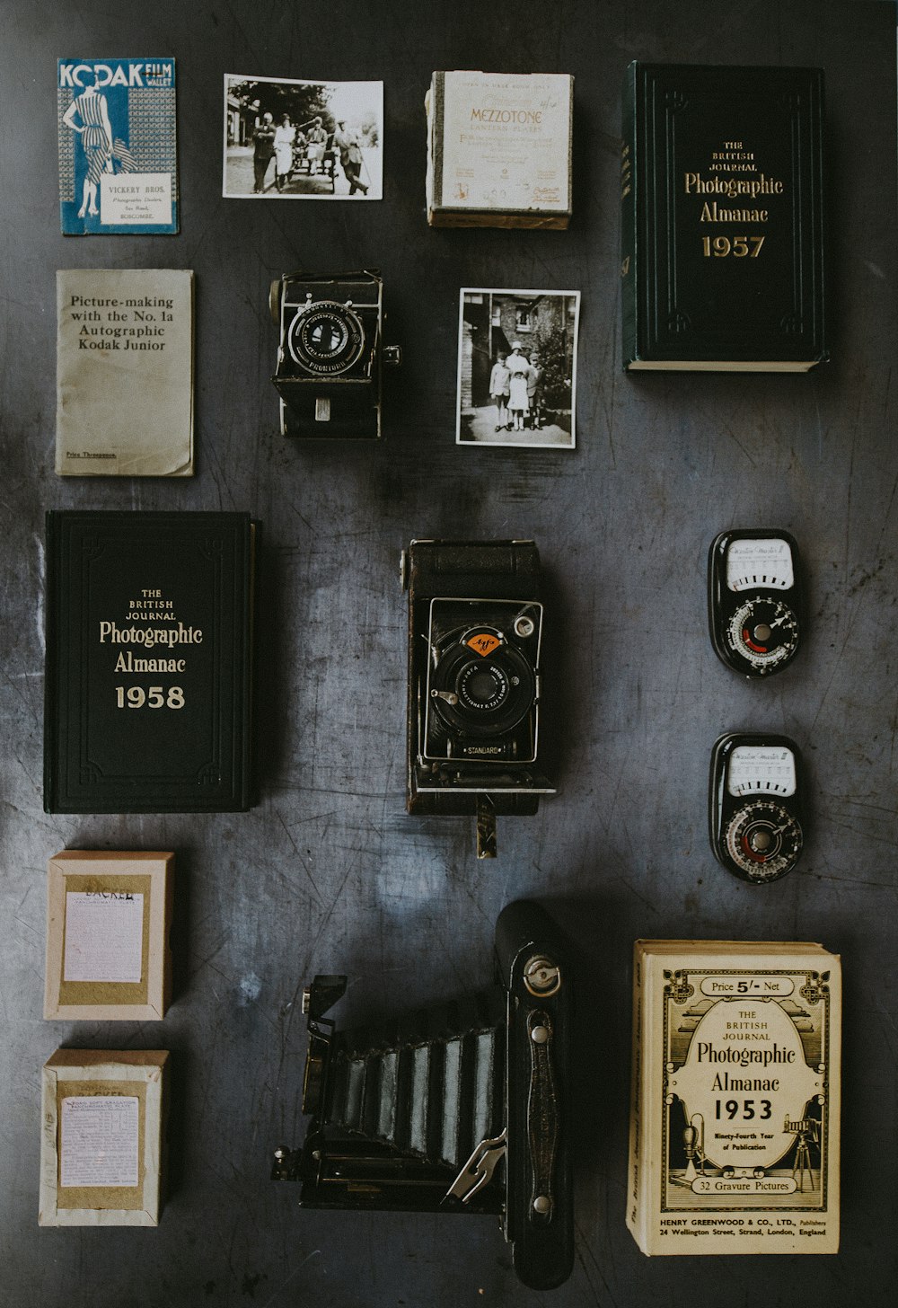 flat lay photography of classic cameras and films
