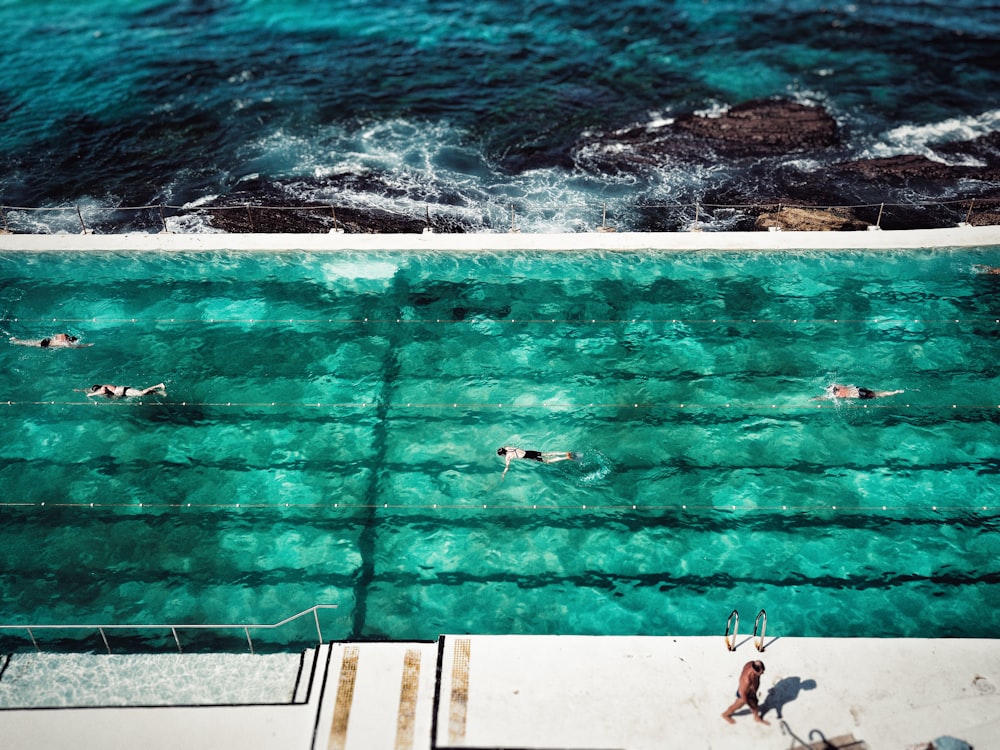 four people on swimming pool