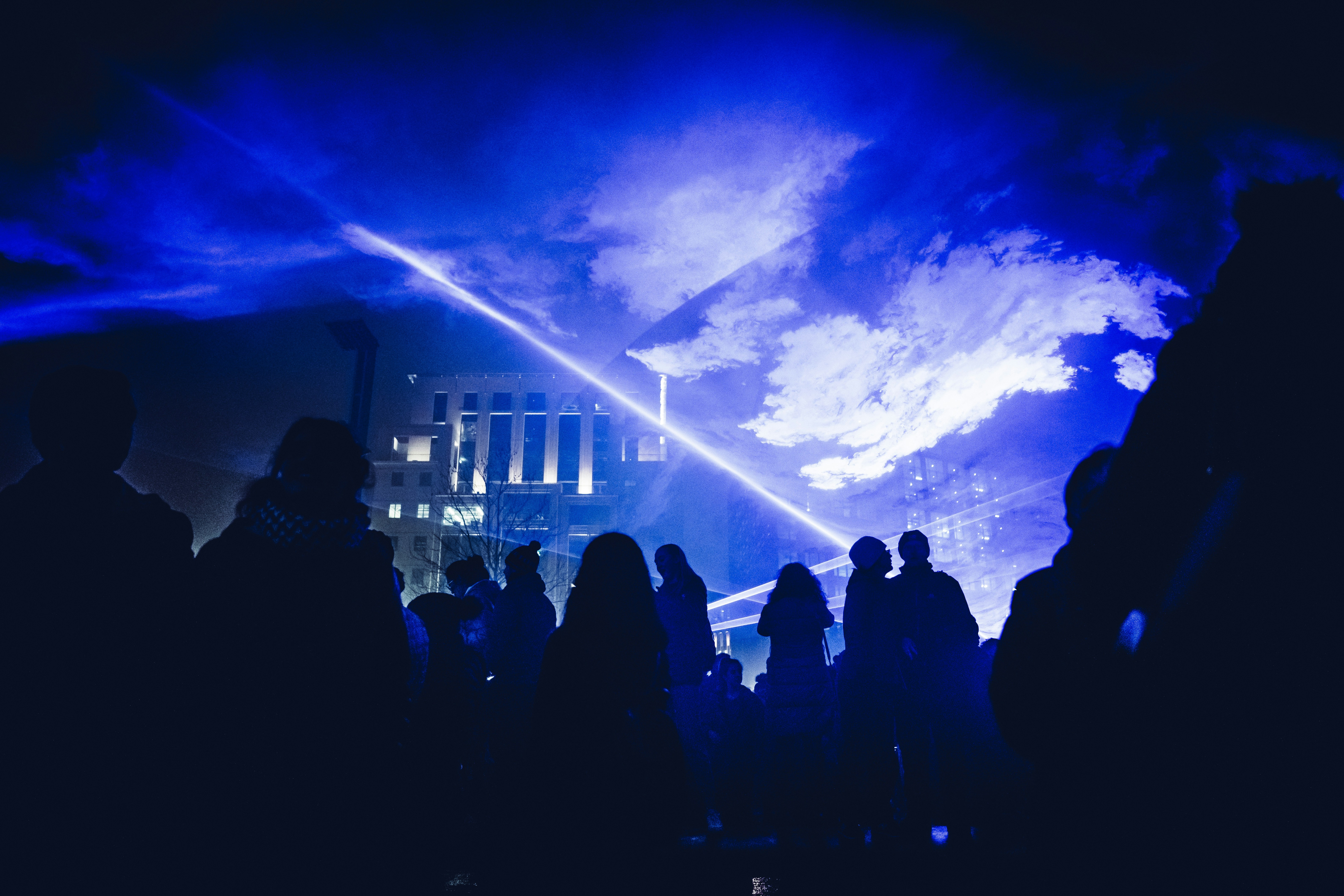 crowd of people under hologram