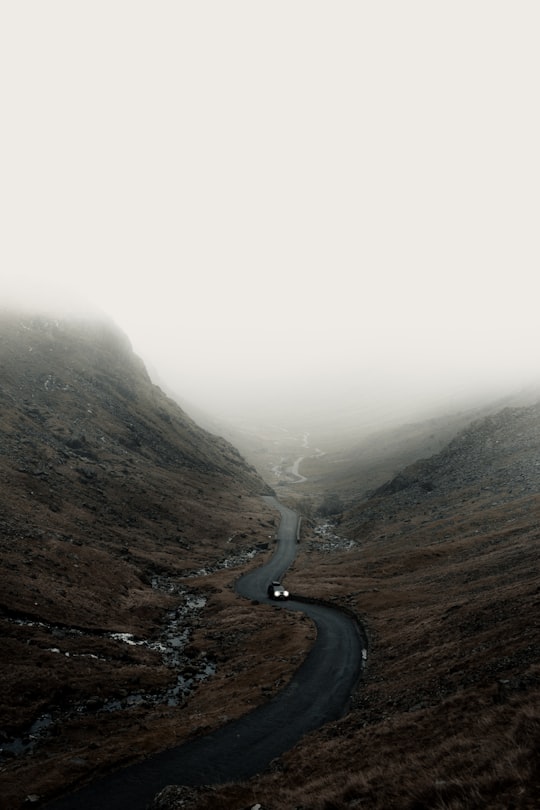 road between mountains in Honister Pass United Kingdom