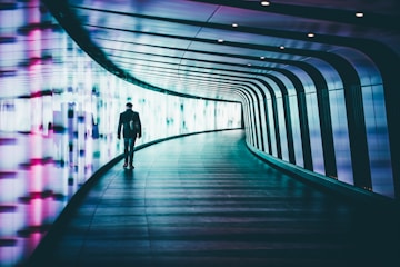 person walking along corridors ]