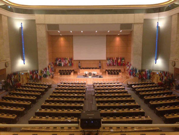 Simultaneous interpretation booth set up at a government meeting with multiple language channels displayed