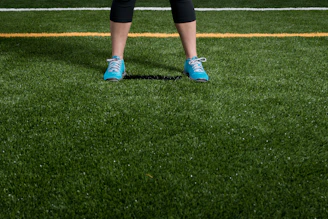 person standing on green grass field