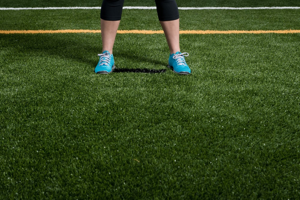 person standing on green grass field