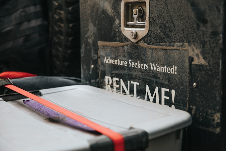 white plastic container beside rent me signage