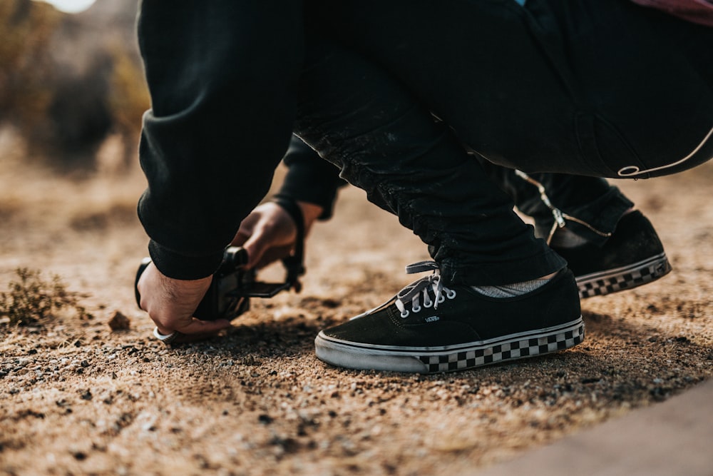 person on brown sand using DSLR camera