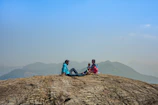 Family enjoying a peaceful afternoon on the terrace overlooking the rocky outcrop.