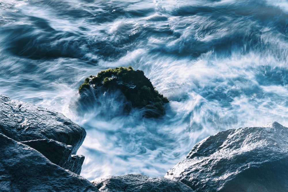 Stock rock in body of water photo – Free Blue Image on Unsplash