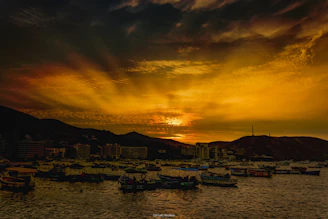 Sunset over a lake with jet skis and boats docked, ready for evening adventures.