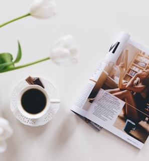 top view of opened magazine near up of coffee