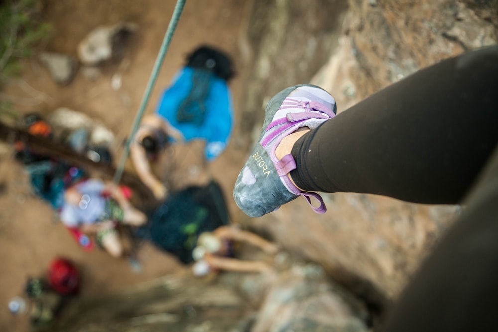 a person standing on top of a cliff next to a group of people