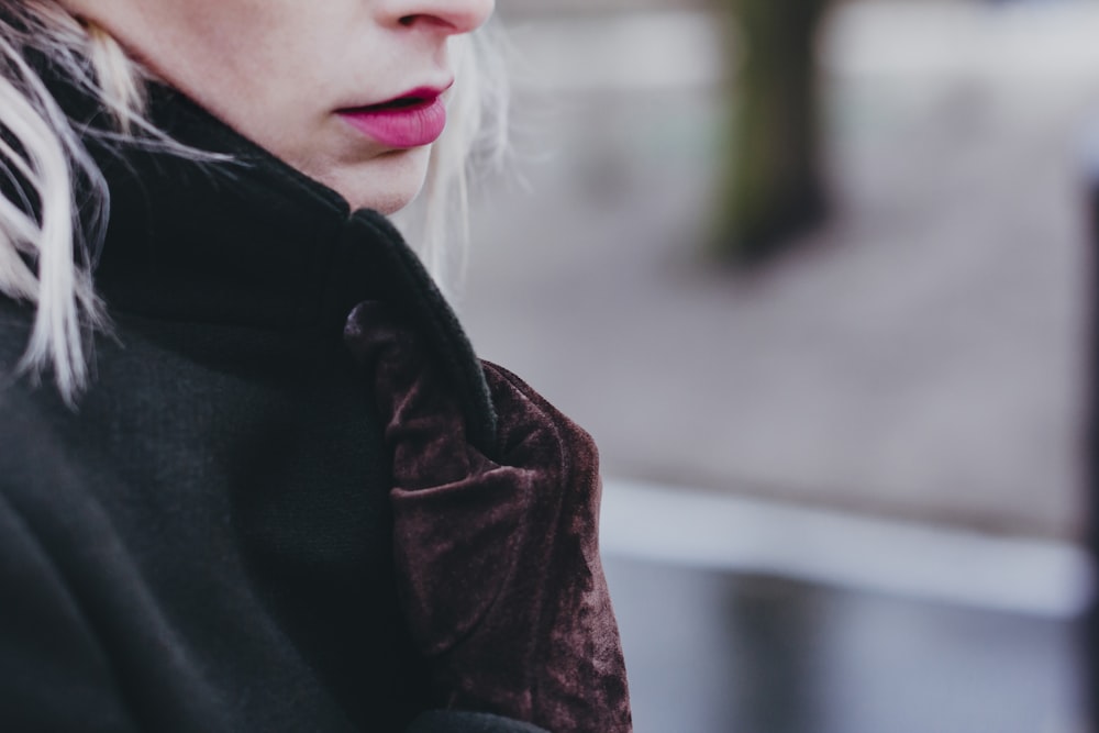 closeup photo of woman wearing black and brown top