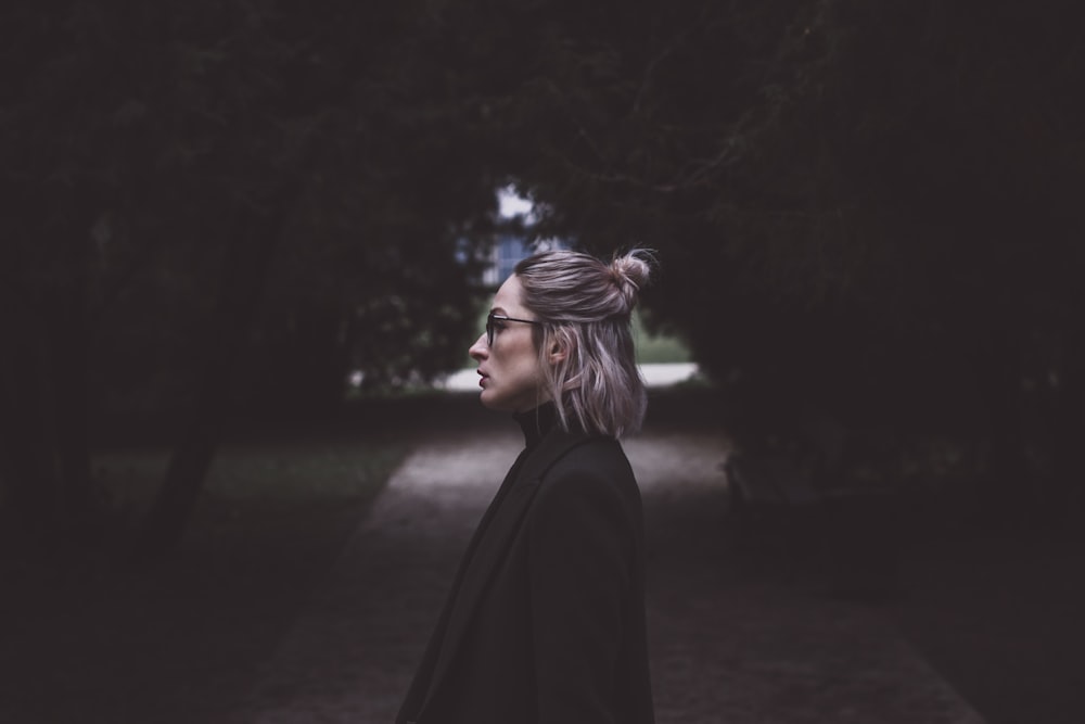 woman standing in between trees