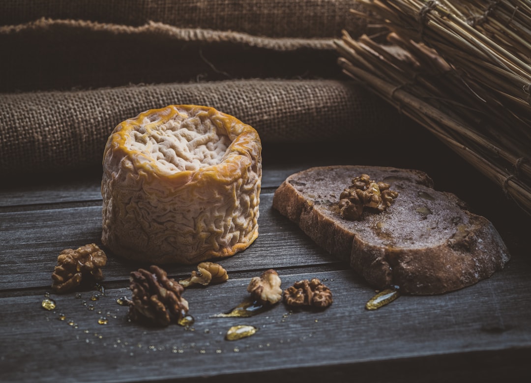 pine cones beside cheese on brown wooden plank, Say cheese!