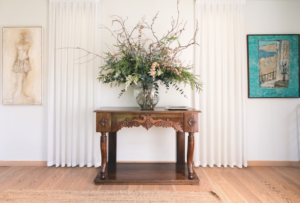 green leafed plant on vase near wall