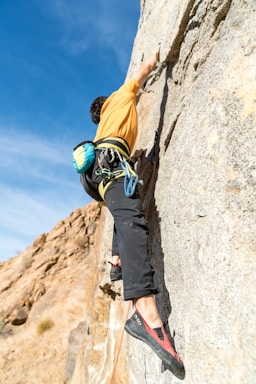 man climbing up on mountain