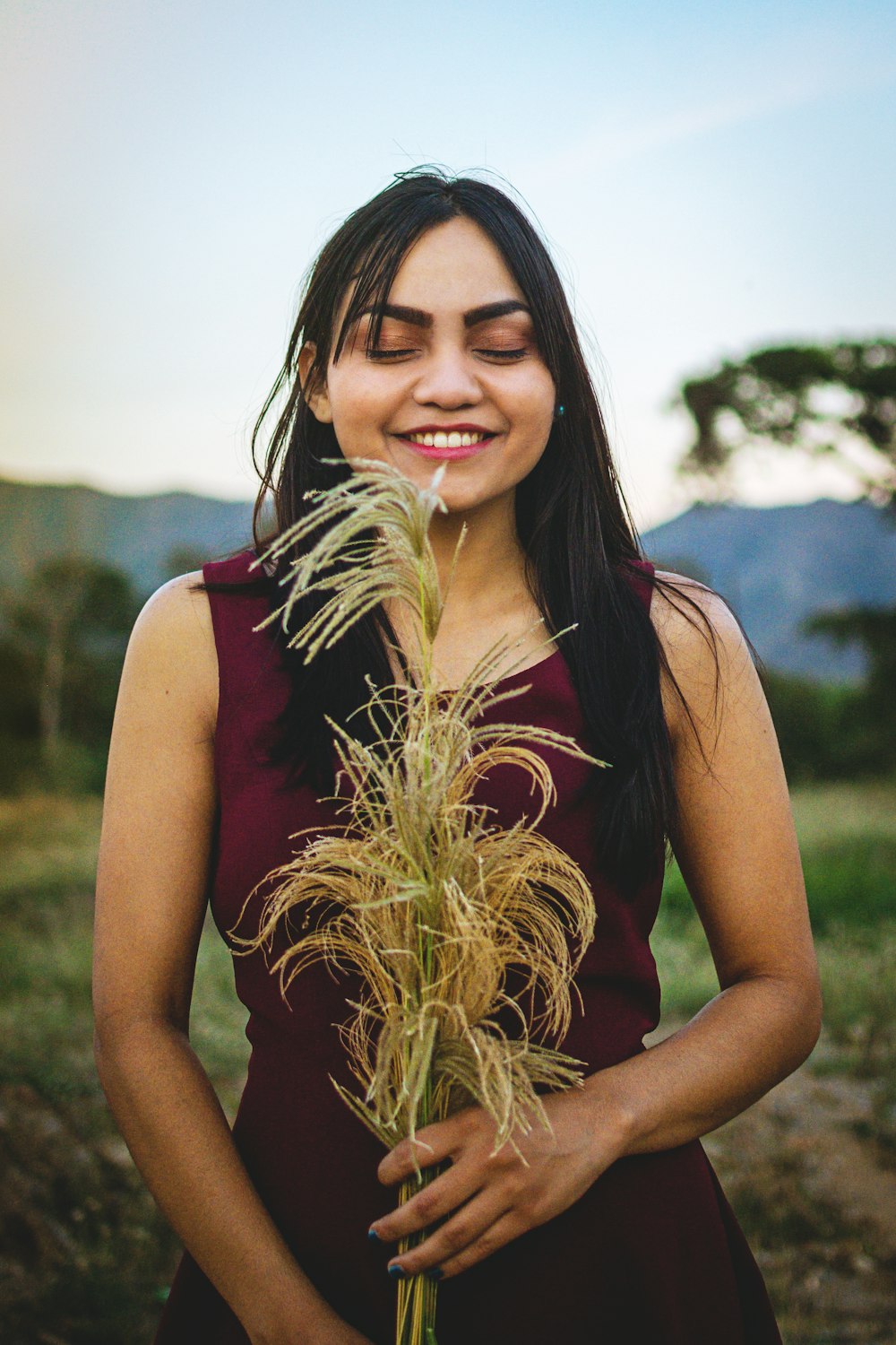 woman standing while holding plant