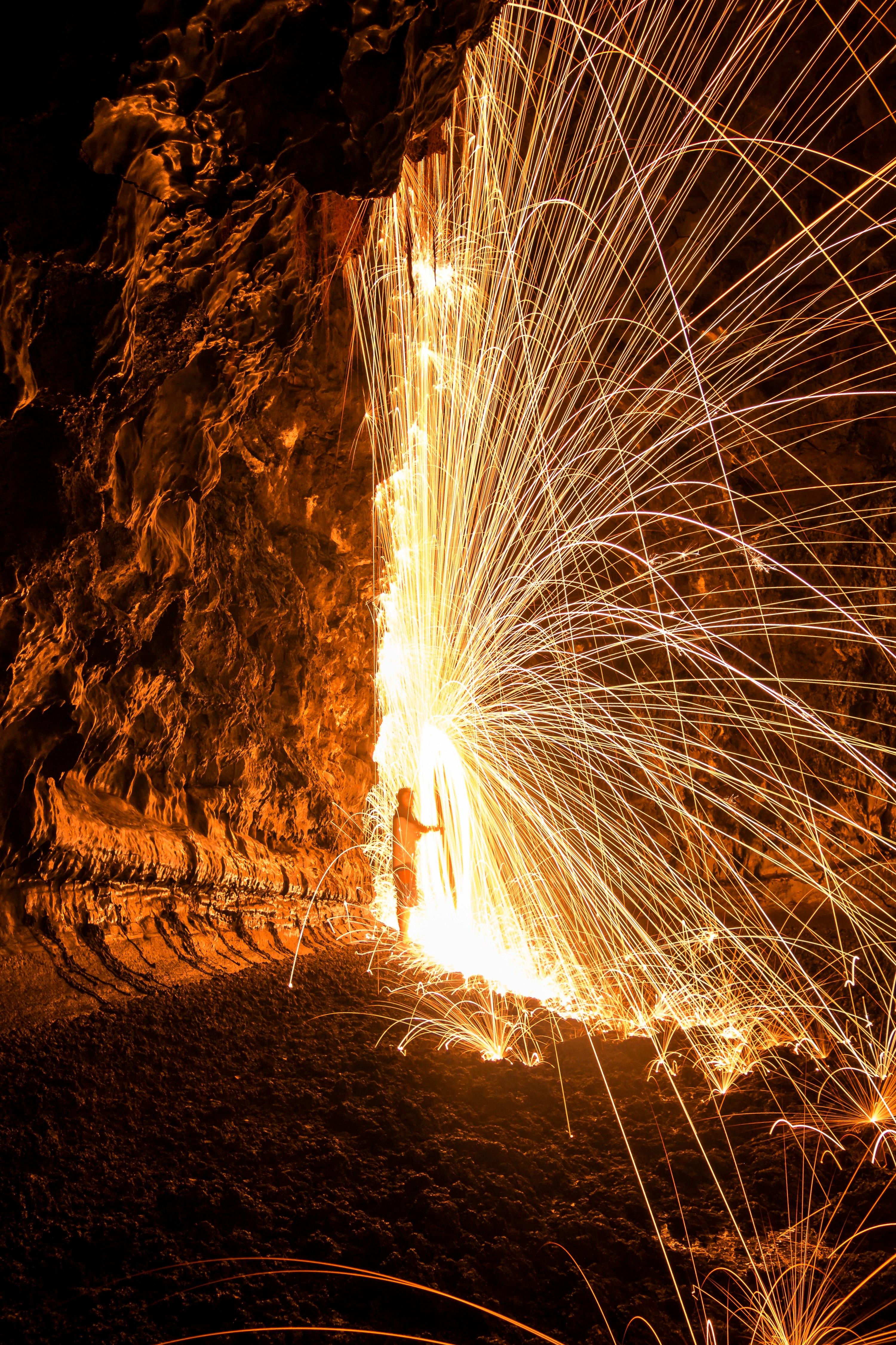 man standing in the middle of sparks