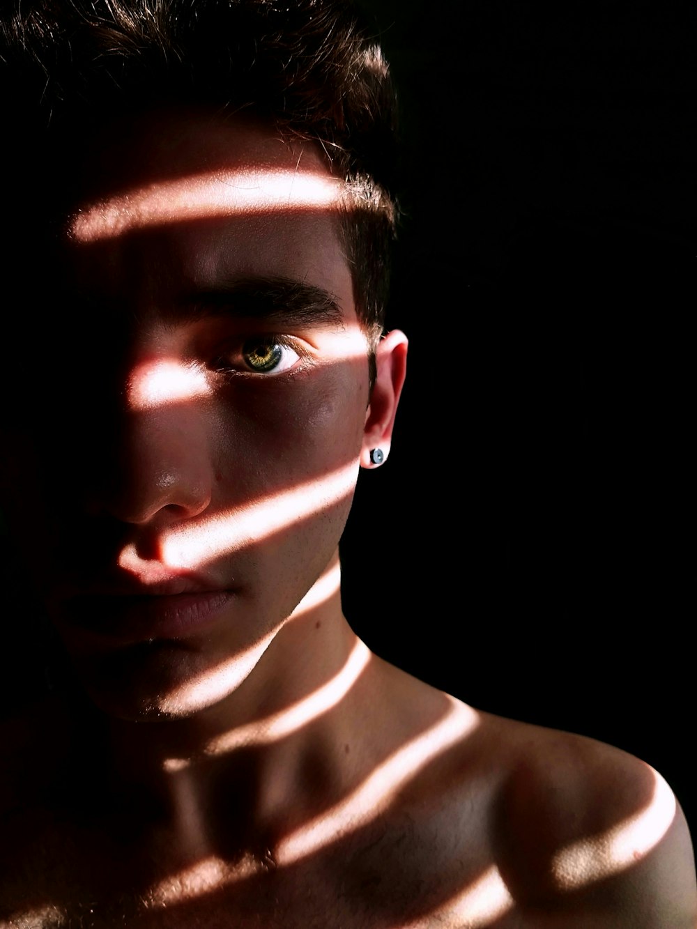 photo of man indoor photography using window blinds lightning