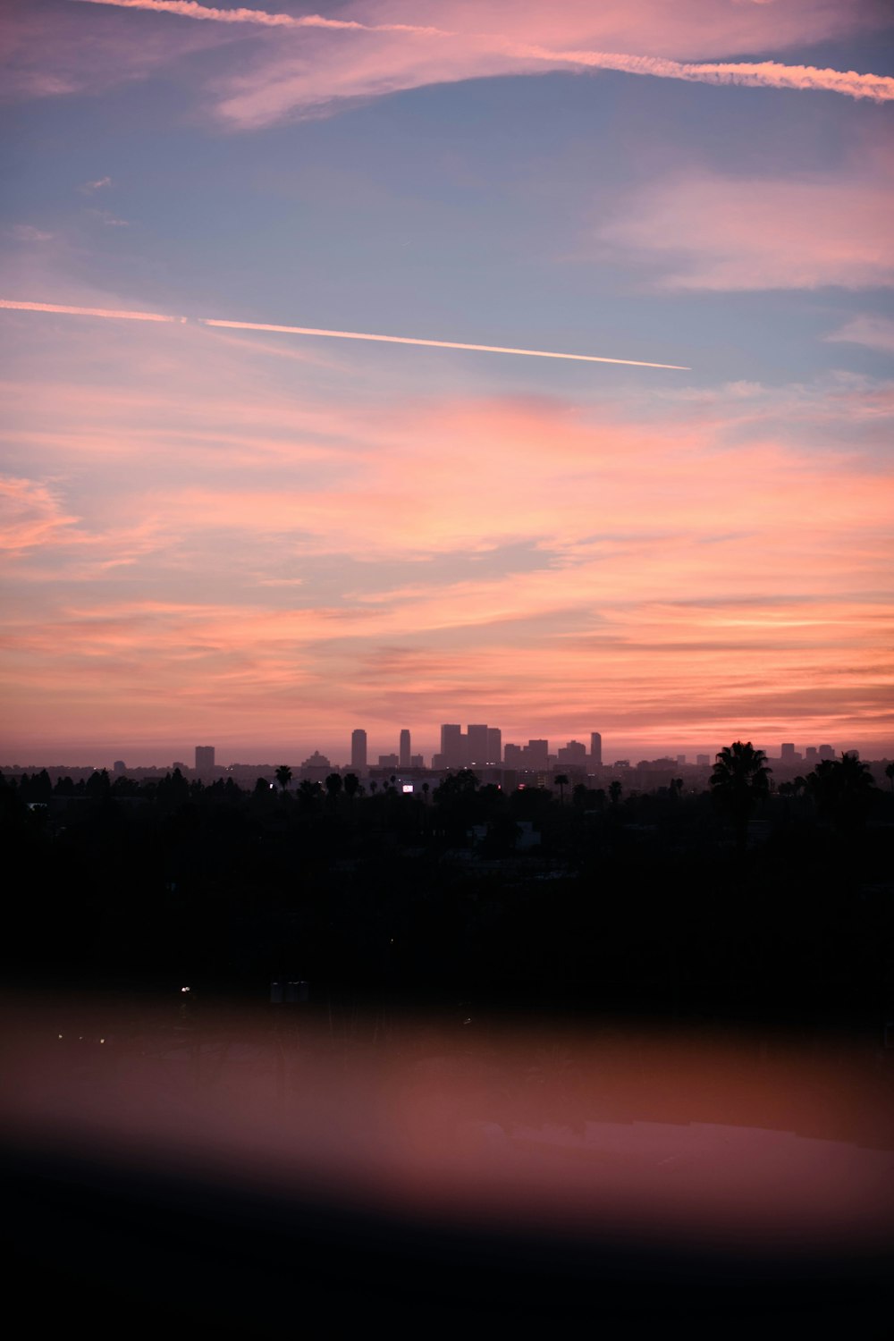 pink sky at sunset over city