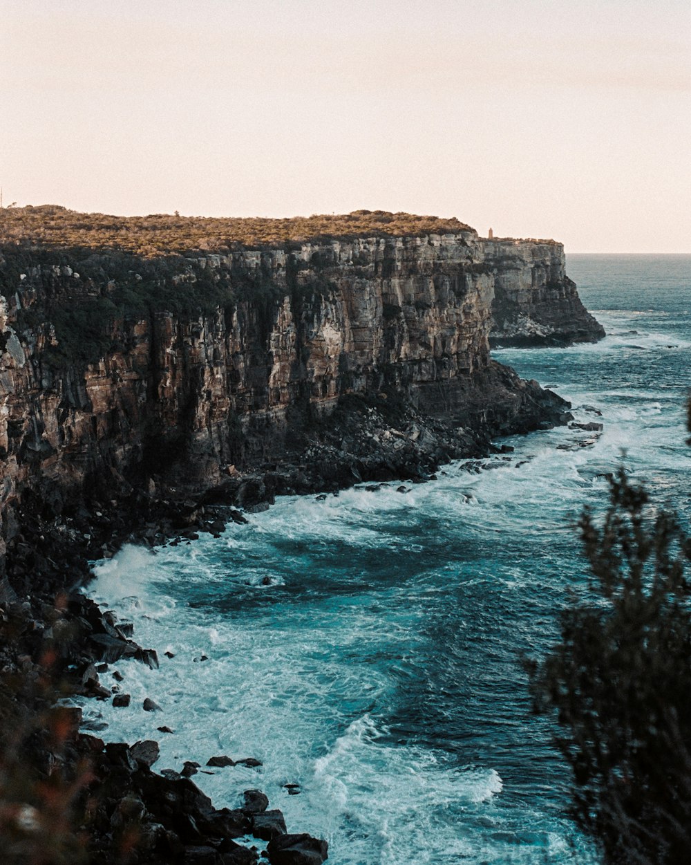 brown cliff near shoreline