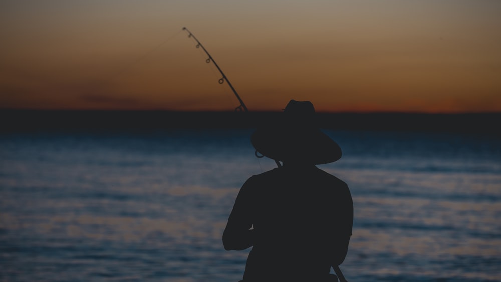 silhouette of person fishing