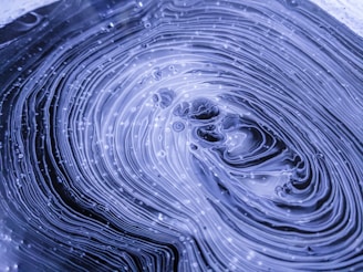 a close up of a water droplet with a blue background
