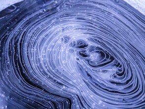 a close up of a water droplet with a blue background