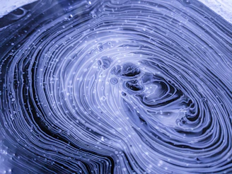 a close up of a water droplet with a blue background