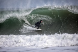 person surfing using white surfboard
