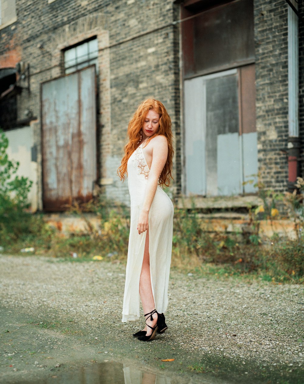 woman standing near brick buildings outdoors