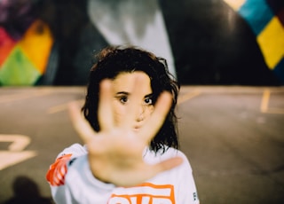 woman wearing white and orange top