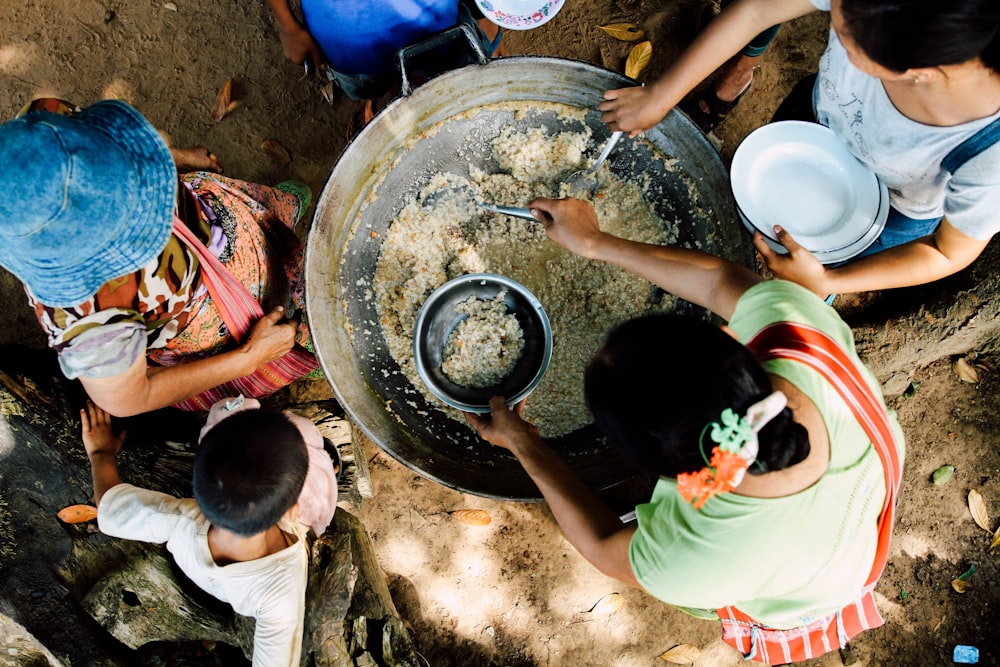 two women scooping rice in bowls