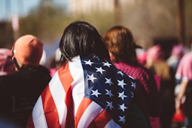 woman with US American flag on her shoulders