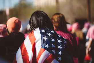 woman with US American flag on her shoulders