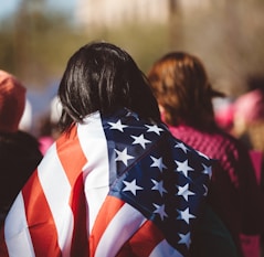 woman with US American flag on her shoulders