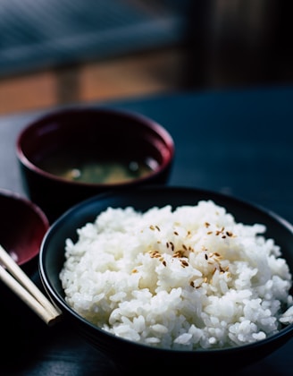 rice with sesame in black bowl