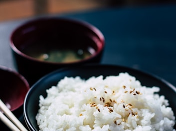 rice with sesame in black bowl