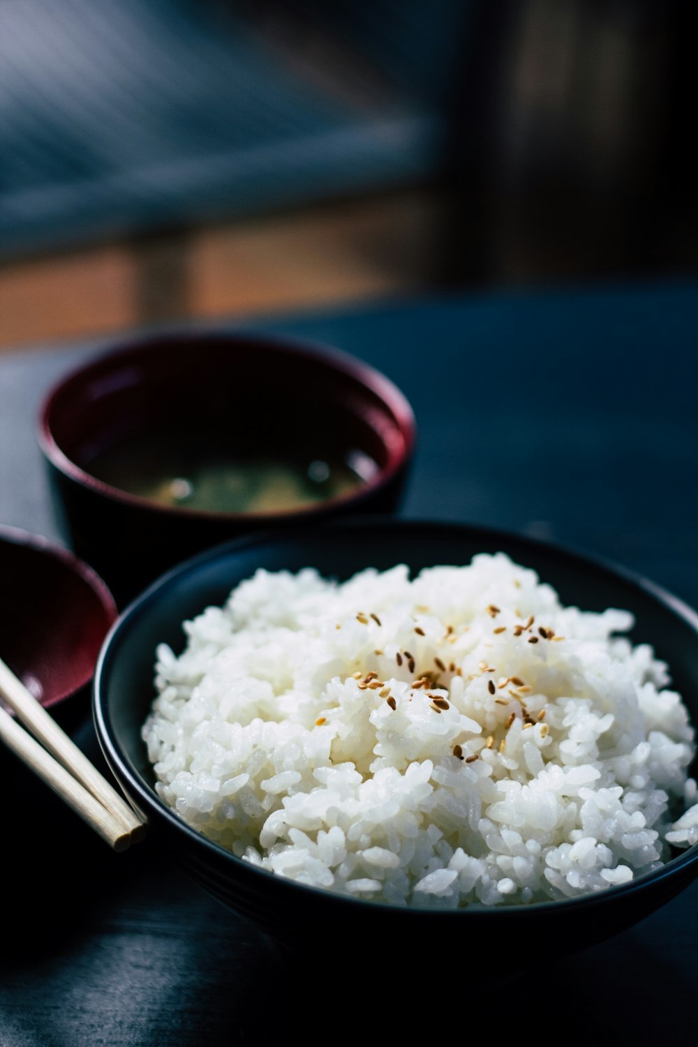 rice with sesame in black bowl