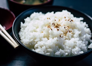 rice with sesame in black bowl